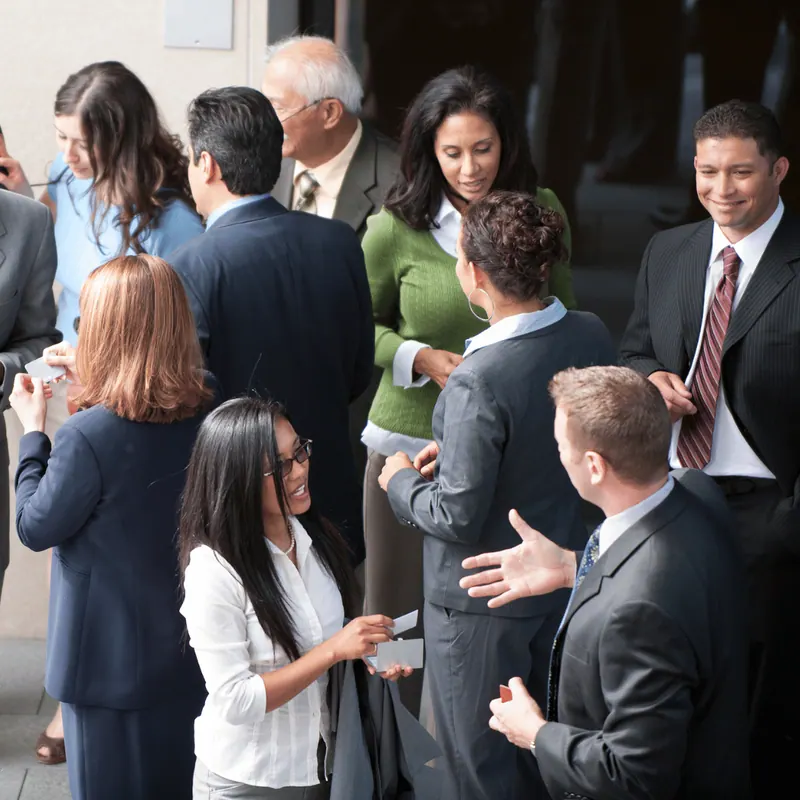 Guests talking in small groups at a networking reception