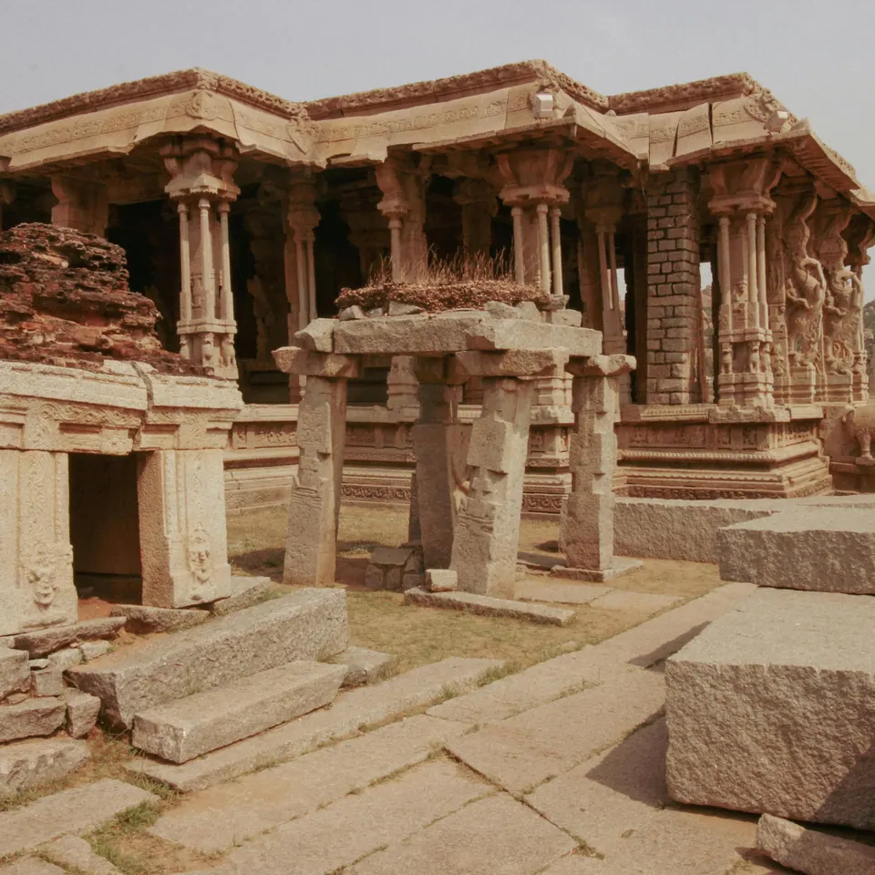 A carved stone temple pavilion among the ruins at Hampi, India
