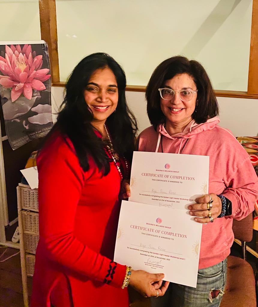 Bhavna Srivastava with a graduate in pink, both holding certificates of completion