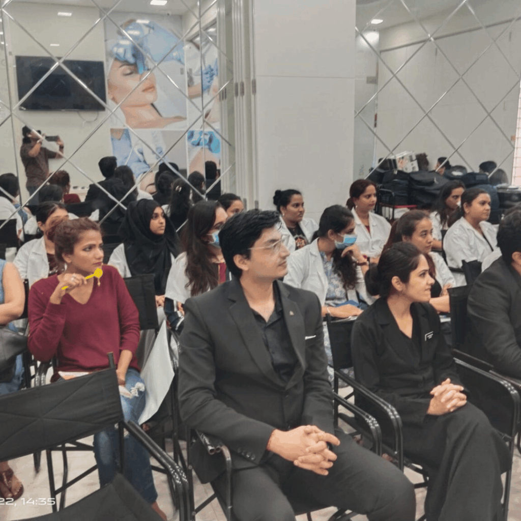An audience seated close together taking part in a workshop session