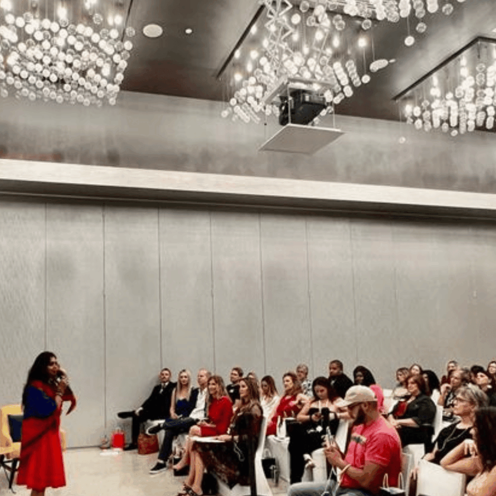 Guests seated in a hotel ballroom listening to a speaker at a wellness event