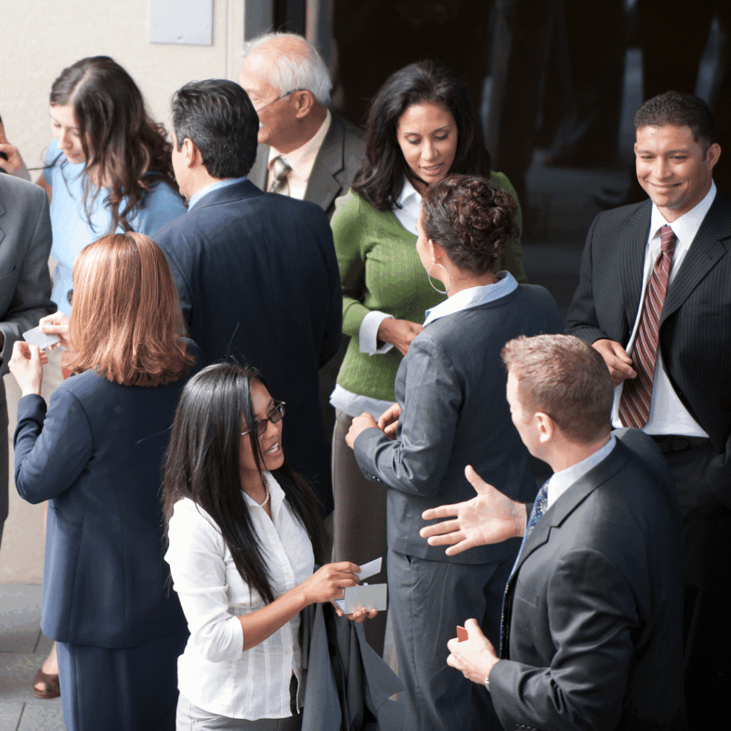 Guests talking in small groups at a networking reception